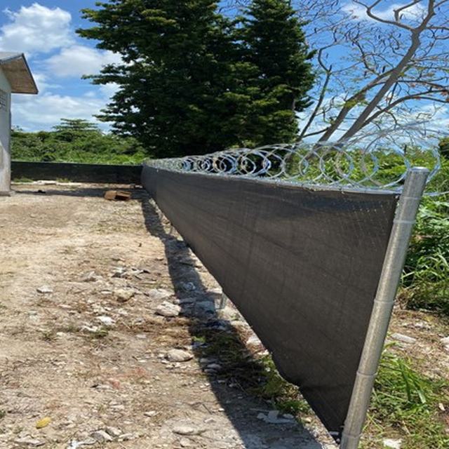 Fence with privacy screen and razor wire